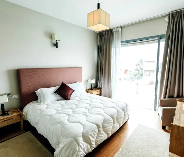 Bedroom remodel with pendant lighting and a patio door