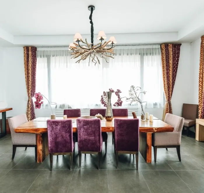 Bright dining room with chandelier and large windows