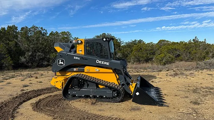 Compact track loader mulching cedar and brush in the Texas Hill Country