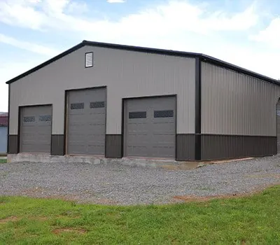 Steel metal building with three roll-up garage doors